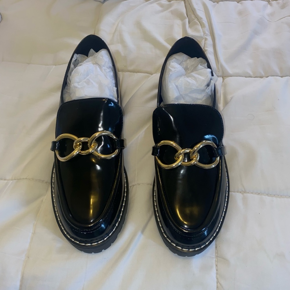Black loafer with gold detail